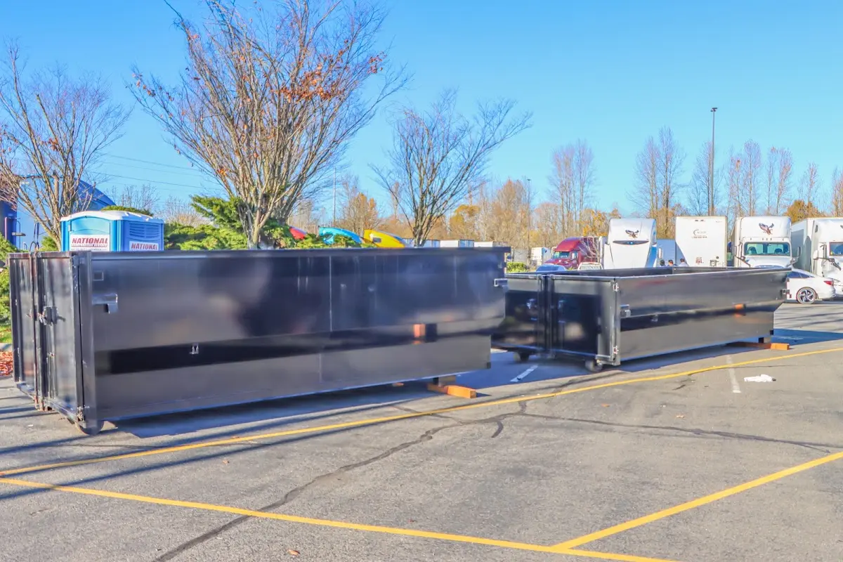 Professional dumpster rental service with roll-off container on residential driveway in Live Oak